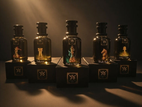 Set of six dark glass bottles with gold labels on a dark background